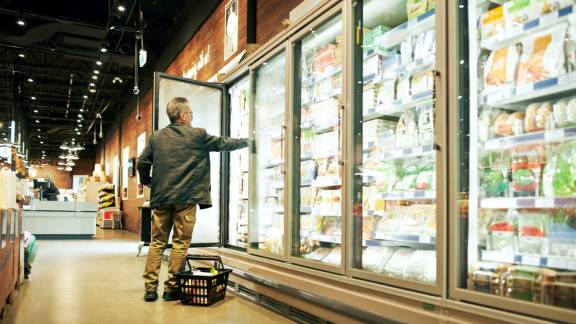 A person looking at a refrigerator