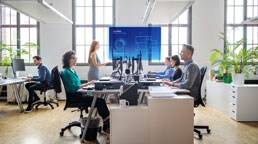 A group of people sitting at desks in an office